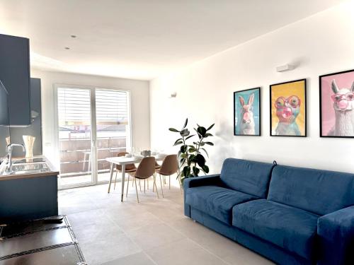 a living room with a blue couch and a table at Jungle - Sarnico Color Suites in Sarnico