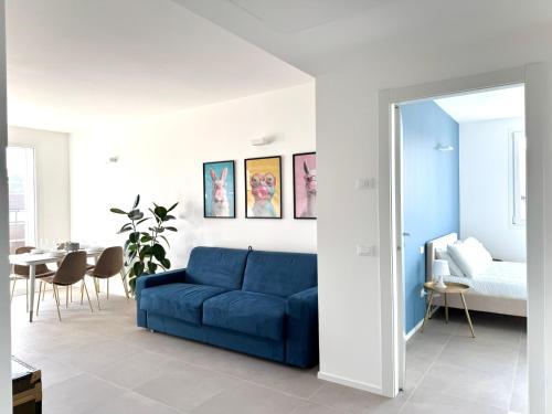 a blue couch in a living room with a bed at Jungle - Sarnico Color Suites in Sarnico