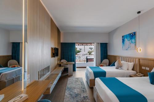 a hotel room with two beds and a window at Basma Hotel Aswan in Aswan