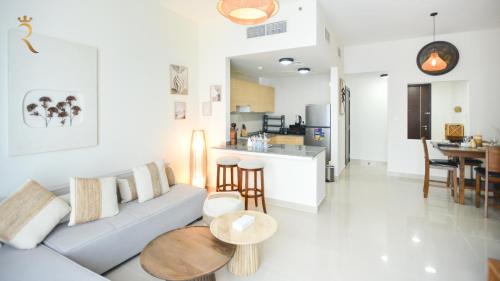a living room with a couch and a table at Azure Marina 1BR - Elegant Chic Haven in Abu Dhabi