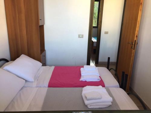 a bedroom with a bed with towels on it at Mya Vacanze in Torre dell'Orso