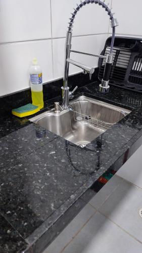a kitchen counter with a sink and a faucet at Águas de Maragogi residence in Maragogi