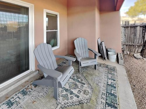 two chairs and a television in a room with a window at Casa Cielo in Santa Fe