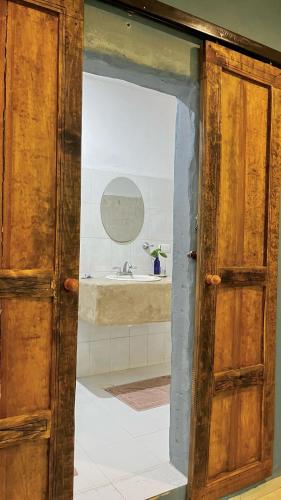 an open door to a bathroom with a sink at Departamento Luna in Valladolid