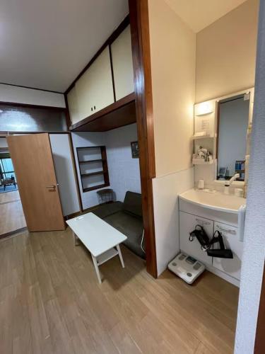 a small bathroom with a sink and a mirror at Modern style old house in Nagoya
