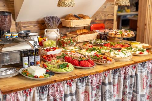 a buffet with many plates of food on a table at Gościniec Rabe - Agro&SPA in Ustrzyki Dolne