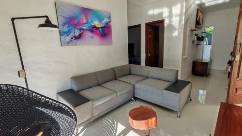 a living room with a couch and a table at Suite en área turística de Manzanillo con club de playa in Manzanillo
