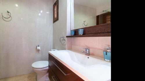 a bathroom with a white sink and a toilet at Son Monget in Muro