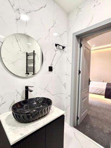 a bathroom with a black sink and a mirror at JM Central Boutique Hotel in Baku