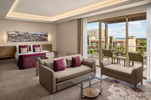 a living room with a couch and a bed at Concorde Luxury Resort & Casino in Vokolidha