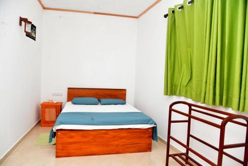 a bedroom with a bed and a green curtain at AERO View Villa in Induruwa