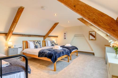a bedroom with two beds in a attic at 4 Bed in Sheringham oc-m28357 in Sheringham