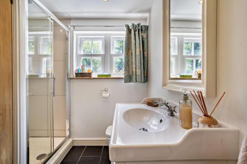 a white bathroom with a sink and a shower at 2 Bed in Blackmill oc-c29623 in Brynmenin