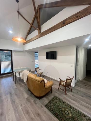a living room with a couch and a table at Little Haven Houses Lousada in Lousada