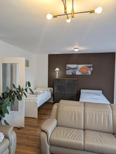a living room with a couch and two beds at Schöne, große Wohnung mit 3 Betten in Bramsche