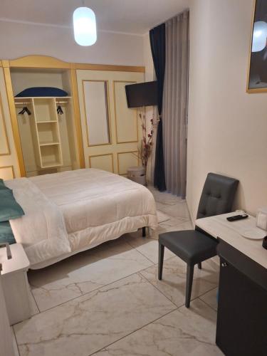 a bedroom with a bed and a desk and a chair at Soleil in Nicosia