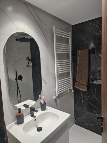 a bathroom with a sink and a mirror at loft in El Aouina Station