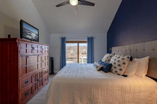a bedroom with a bed with a dresser and a window at Barba Le Lane in Lake Ozark