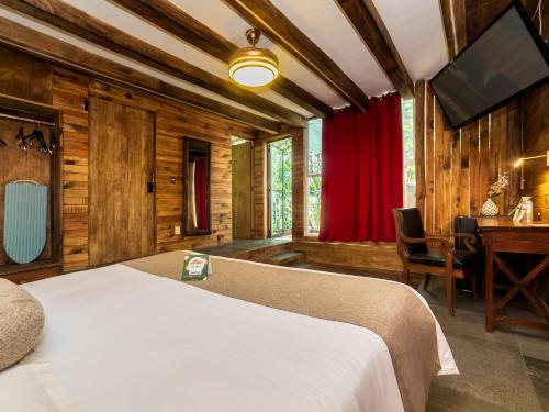 a bedroom with a bed and a desk and a television at Hotel Casa Anzures in Mexico City