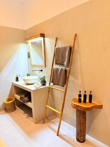 a bathroom with a towel rack and a sink at Edwin's Ahangama in Ahangama