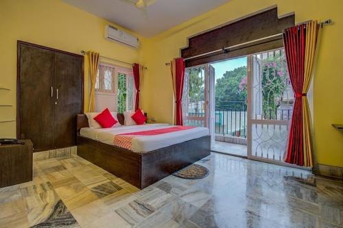 a bedroom with a bed and a large window at ADRIJA Ck 140 Saltlake SEC-ll in kolkata