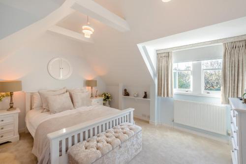 a white bedroom with a bed and a window at 5 Bed in Bosham oc-h33962 in Bosham