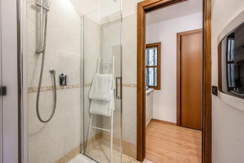 a bathroom with a shower with a glass door at Emilia Studios 4 in Modena