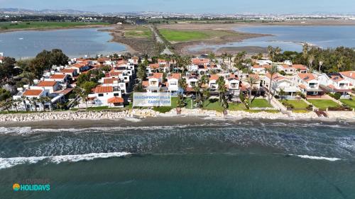 an aerial view of a beach with houses at Beachfront Villa Carpe Diem in Mor Menekshe