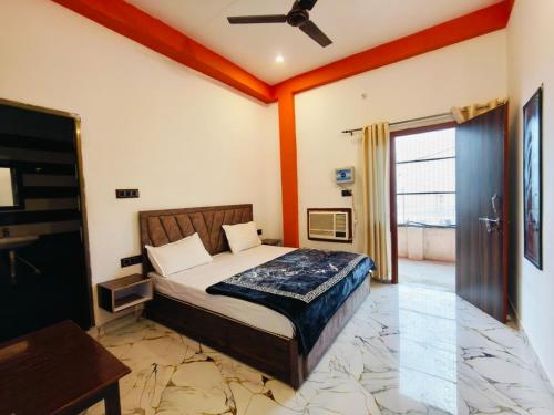a bedroom with a bed and a ceiling fan at The Laxman Palace in Ayodhya