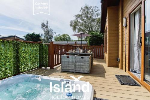 a deck with a hot tub on a house at The Lodge in Ryde