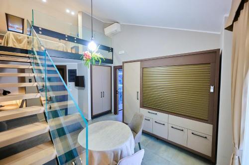 a dining room with a table and a staircase at Le 2 Palme Apartments in Catanzaro Lido