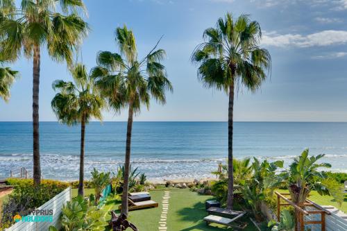 a view of the beach from the balcony of a resort at Beachfront Villa Carpe Diem in Mor Menekshe