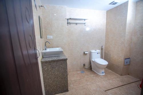 a bathroom with a toilet and a sink at Hotel Ganga Sagar in Kathmandu