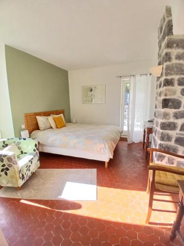 a bedroom with two beds and a fireplace at Mas Bella Vida - Chambres d'Hôtes in Puget-Théniers