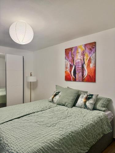 a bedroom with a bed with a painting on the wall at Q80 Appartement in Schermbeck