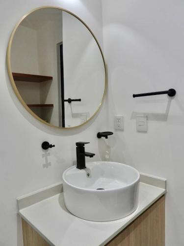 a white bathroom with a sink and a mirror at NEW! Jungle Chic Retreat in Aldea Tulum in Tulum