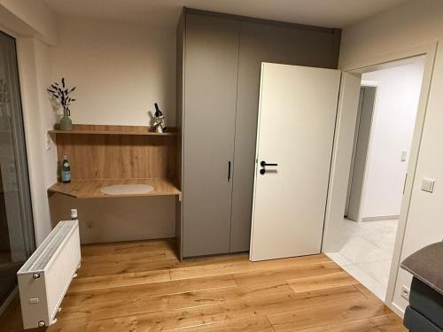 a room with a white door and a wooden floor at Mountain Lodge - Design Apartment in Winterberg