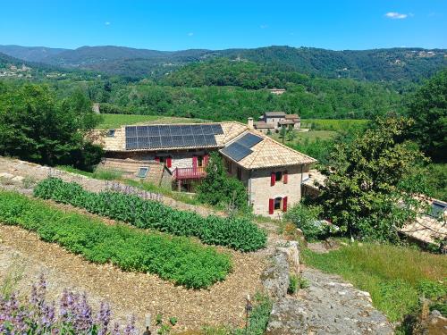 a house with solar panels on top of a hill at Aqua Terra Silva in Gravières
