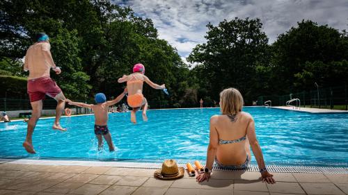 a group of people playing in a swimming pool at CAMPING ETXARRI in Echarri-Aranaz