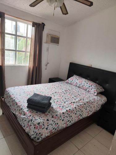 a bedroom with a bed with a comforter on it at Casa Ixtapa in Ixtapa