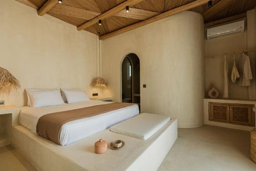a bedroom with a large bed in a room at Maria's place boutique hotel in Antiparos