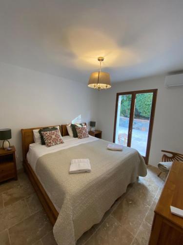 a bedroom with a large bed and a window at Maison Tropez in Cogolin