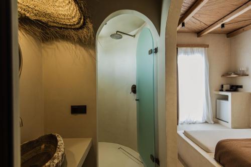 a bathroom with a shower and a toilet in a room at Maria's place boutique hotel in Antiparos
