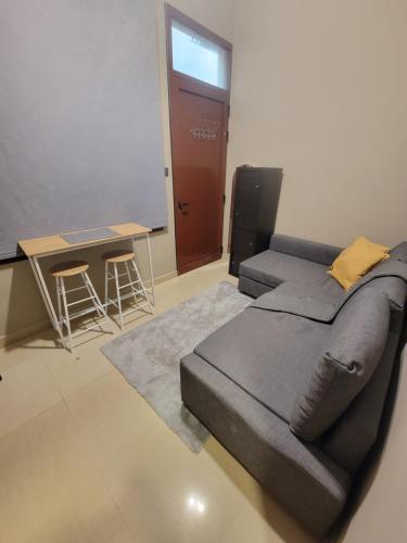 a room with a bed and a table and a desk at Cozy, Tiny, Retreat Studio in a prime location in Abu Dhabi