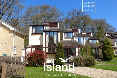 a house with the island holiday homes sign in front of it at Villa 23 in Wootton Bridge