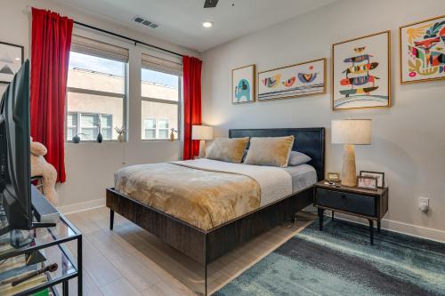 a bedroom with a bed with red curtains and a tv at 12 Mi to DTLA! Multi-Level Charmer w/ Pool Access in Montebello