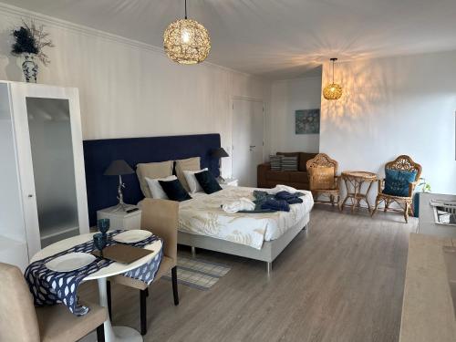 a bedroom with a bed and a living room at Casa Caloura Ocean Deluxe Accommodation & Spa in Lagoa