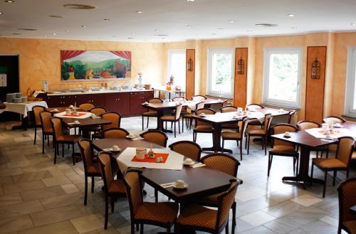 a dining room filled with tables and chairs at Hotel Heidenschanze in Dresden