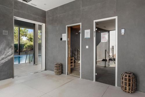 an empty room with two doors and a pool at Casa Costa Tropical in Estepona