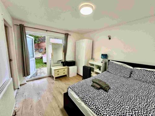 a bedroom with a bed and a large window at Recently fully refurbished --January 2026-- private en-suite room with brand-new bathroom and private entrance in Oxford